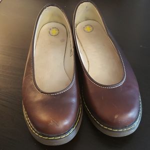 Dr. Martens brown slip on shoes.